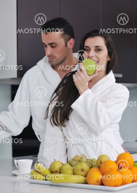 young couple have fun in modern kitchen