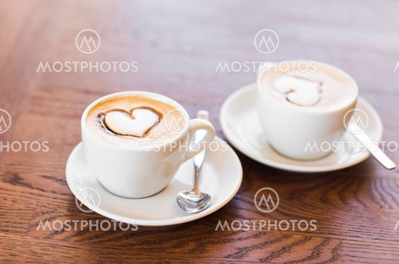 Two cups of coffee with heart pattern