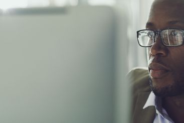 Computer, business or black man reading email for...