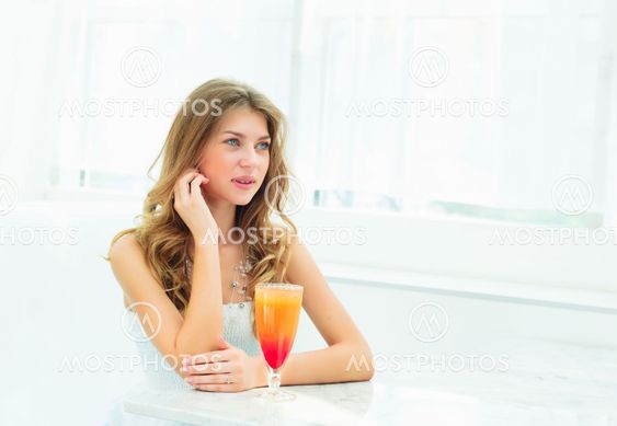 Portrait of a cute woman in a city cafe
