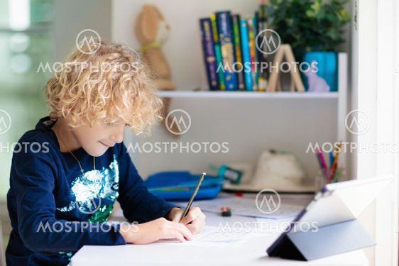 Online remote learning. School kids with computer.