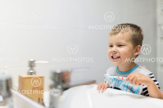 Adorable child brushing his teeth