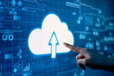 A hand presses cloud technology on a futuristic display