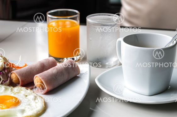 breakfast with fried eggs, juice and coffee