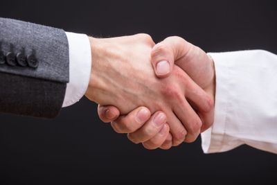 Doctor And Businessman Shaking Hands