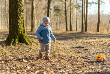 Happy baby child outdoor. Little toddler boy with toy...