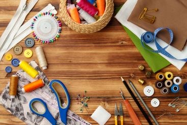 Crafting tools and materials arranged on a wooden table...