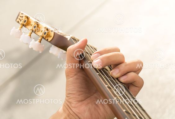 hand playing on guitar