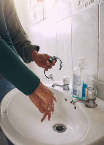 Water, soap and couple washing hands in bathroom for...