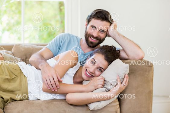 Portrait of young couple relaxing on sofa