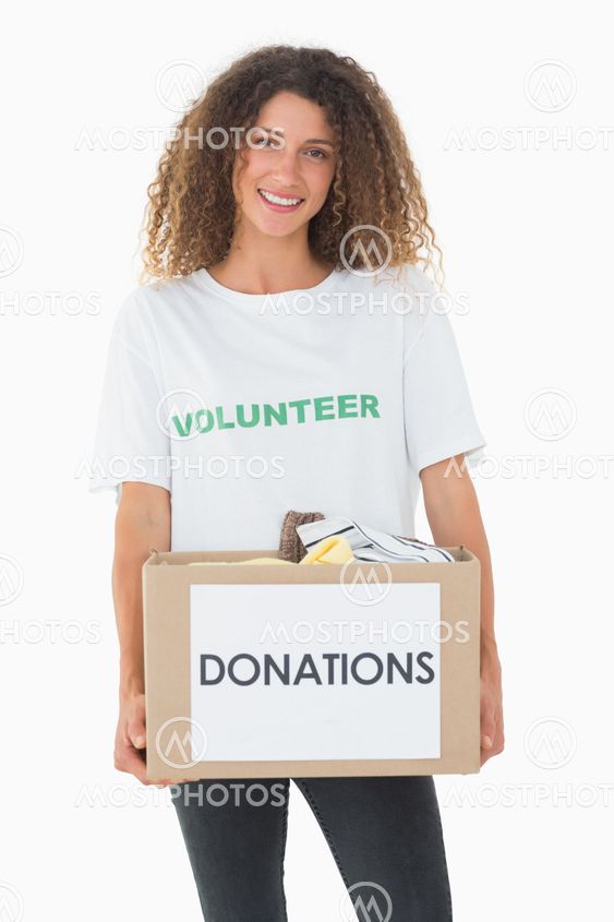 Smiling volunteer holding a box of donations