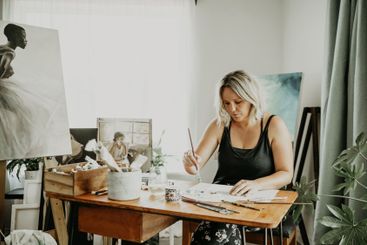 Creativity, studio and woman painting in her house on a...