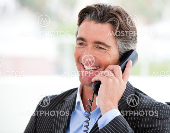 Portrait of a smiling businessman on phone