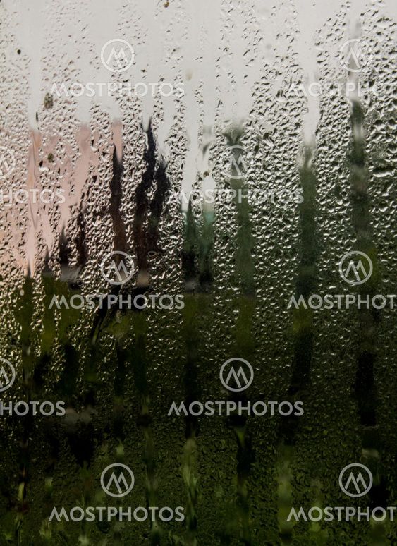 the view through the window of a country house in rainy...