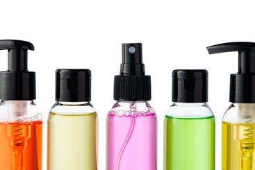 Various bottles with colored liquids and pumps arranged...