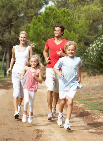 Family running on path in park