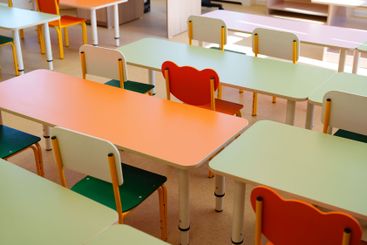 Brightly colored classroom furniture arranged in a...