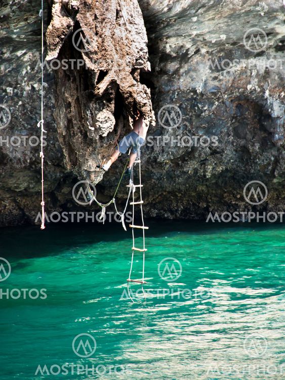 Young men are climbing.