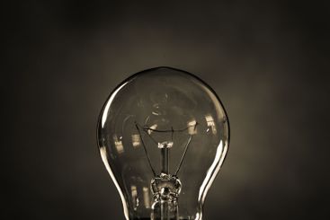 Close-up of electrical bulb on black background