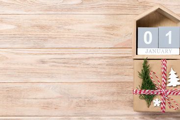 Calendar with date 1 january and gift boxes on color...