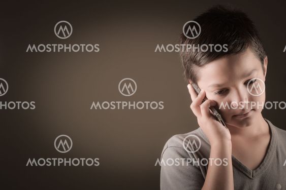 Studio Shot Of French Boy With Mobile Phone