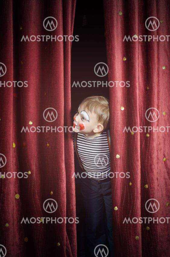Boy Dressed Up as Clown Peeking Thru Stage Curtain