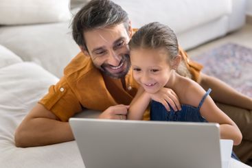 Portuguese family using modern laptop at home