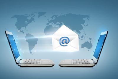 two laptop computers with world map hologram