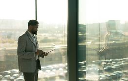 Business professional engages with a tablet while...