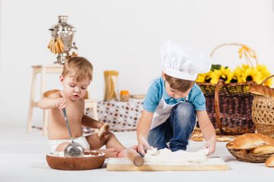 Little girl and funny boy wearing chef hats 