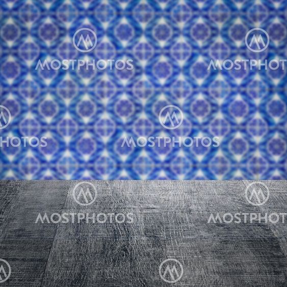 Wood table top and blur vintage ceramic tile pattern wall