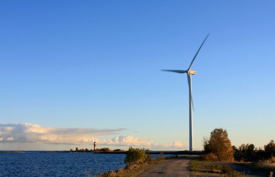 Power plant and lighthouse in evening lit.