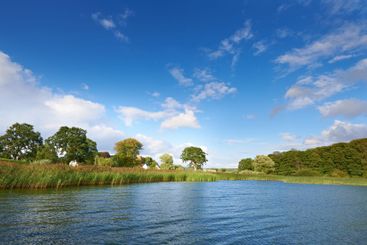 Blue sky, clouds and summer with lake in nature for...