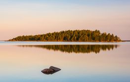Morning light casts a serene glow over Lake Vanern in...