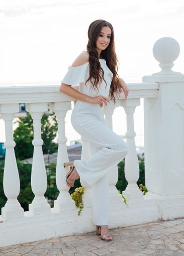 Beautiful fashionable brunette woman in white suit...