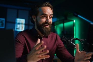 Man using microphone and mobile phone to film ASMR video