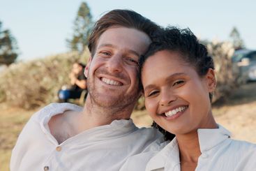 Love, interracial couple and smile in portrait outdoor...