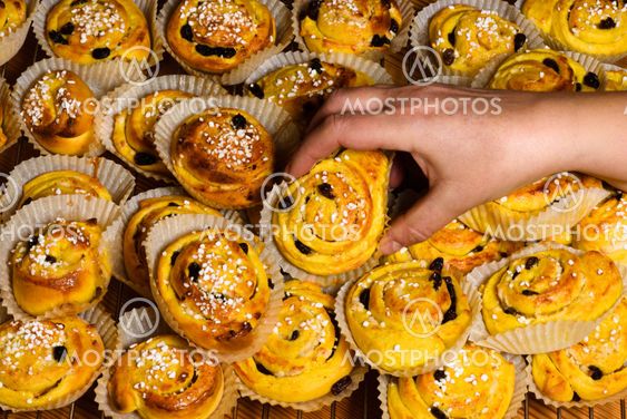 Female hand grabbing a saffron bun