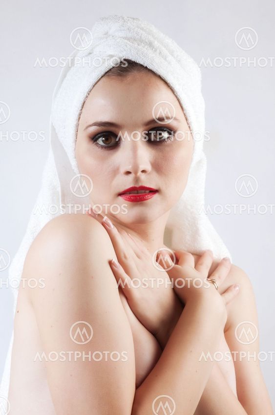 Young beautiful girl in the sauna towel