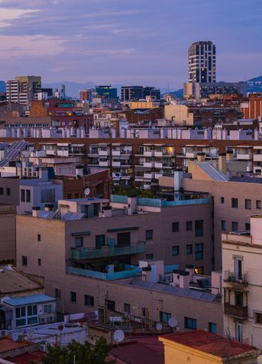 Barcelona cityscape view at dusk, featuring buildings,...