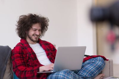 man freelancer in bathrobe working from home