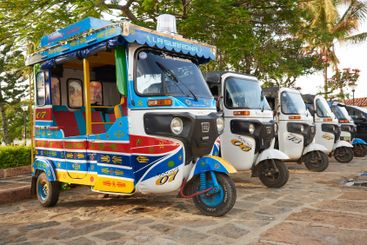 Colourful motorcycle cabs awaiting for tourists in...