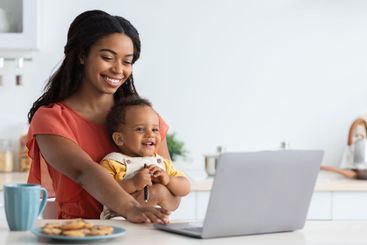 Freelance And Motherhood. Black Woman Holding Baby And...
