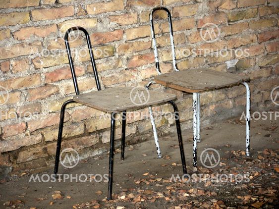 Chairs in front of brick wall