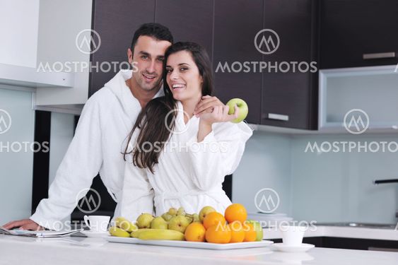 young couple have fun in modern kitchen