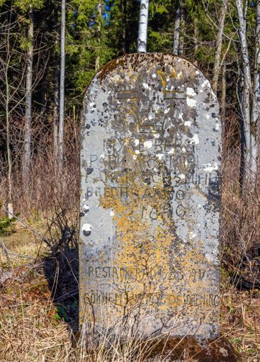Old boundary stone with inscriptions in Swedish text...