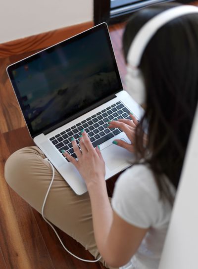relaxed young woman at home working on laptop computer