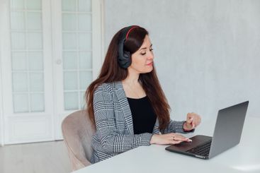 woman brunette sitting at table chatting online business