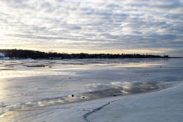 frozen surface of river in Kostroma in winter dusk