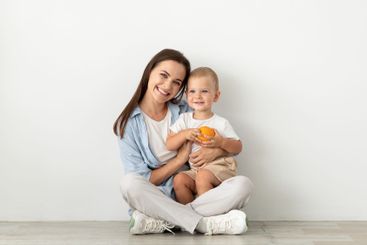 Motherhood Concept. Beautiful Young Woman Sitting On...